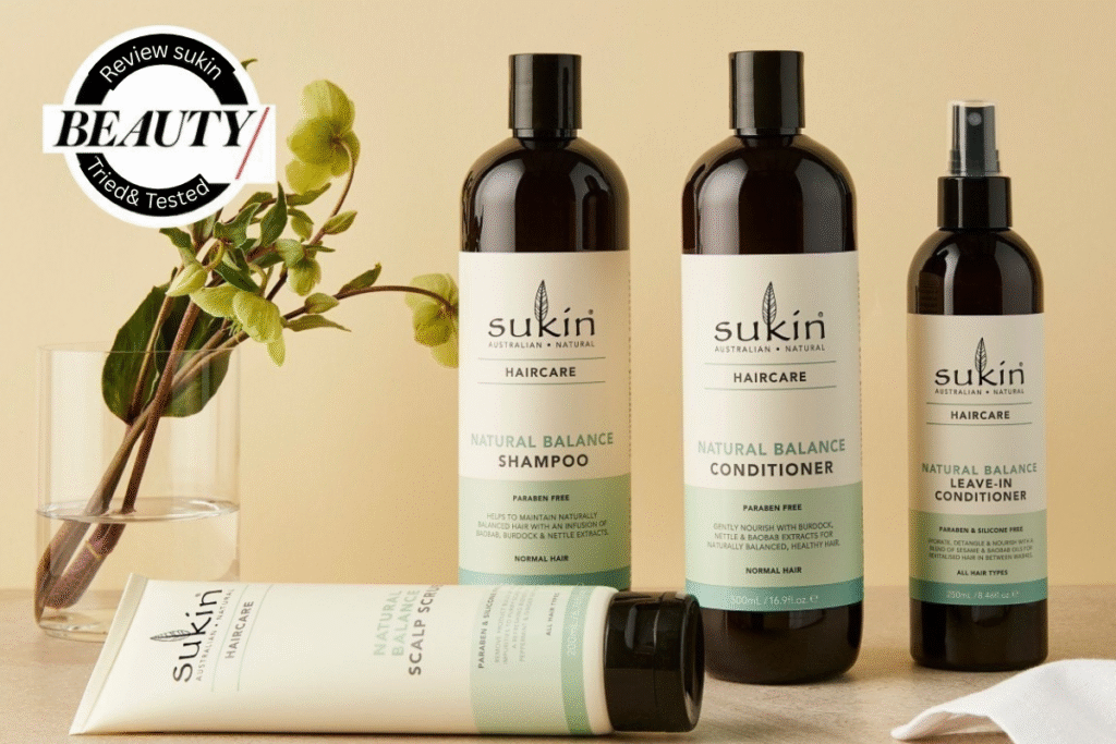 A bottle of Sukin Natural Balance Shampoo for normal hair displayed on a clean, white marble surface with botanical leaves in the background.
