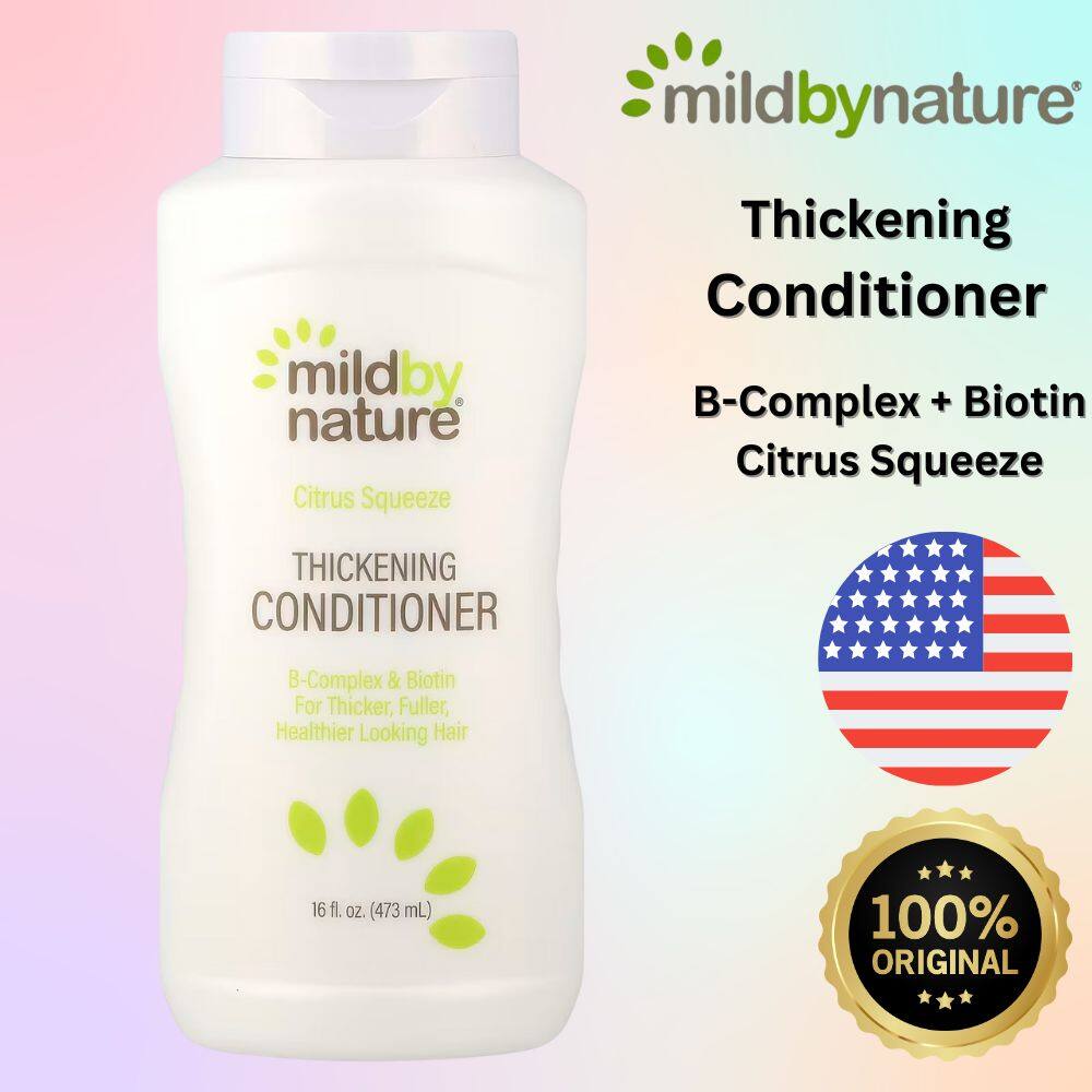 A bottle of Mild By Nature Gentle Thickening Shampoo Citrus Squeeze on a clean bathroom counter, highlighting the Biotin and B-Complex label for hair thickening shampoo for thinning hair