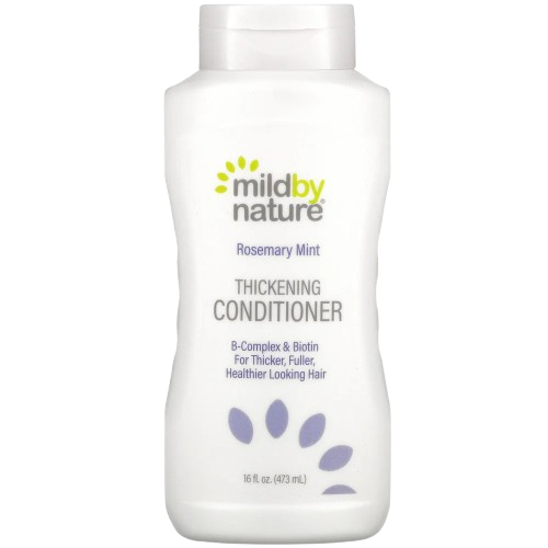 A bottle of Mild By Nature Gentle Thickening Shampoo Citrus Squeeze on a clean bathroom counter, highlighting the Biotin and B-Complex label for hair thickening shampoo for thinning hair