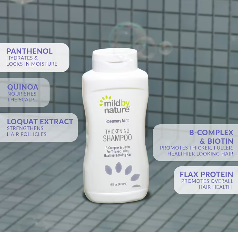 A bottle of Mild By Nature Gentle Thickening Shampoo Citrus Squeeze on a clean bathroom counter, highlighting the Biotin and B-Complex label for hair thickening shampoo for thinning hair