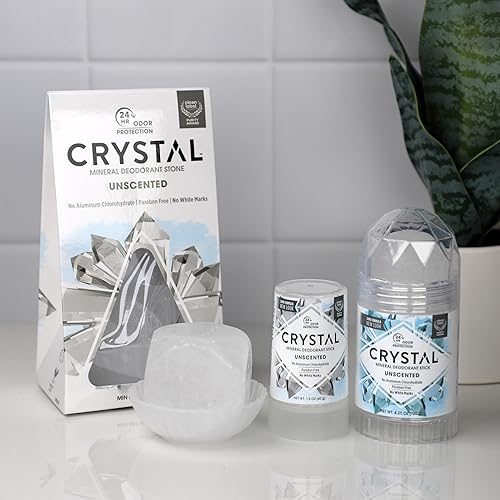 A 120g CRYSTAL mineral deodorant stick unscented sitting on a bathroom counter, showcasing its clear natural salt stone texture