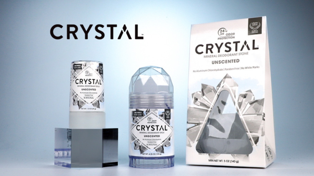 A 120g CRYSTAL mineral deodorant stick unscented sitting on a bathroom counter, showcasing its clear natural salt stone texture